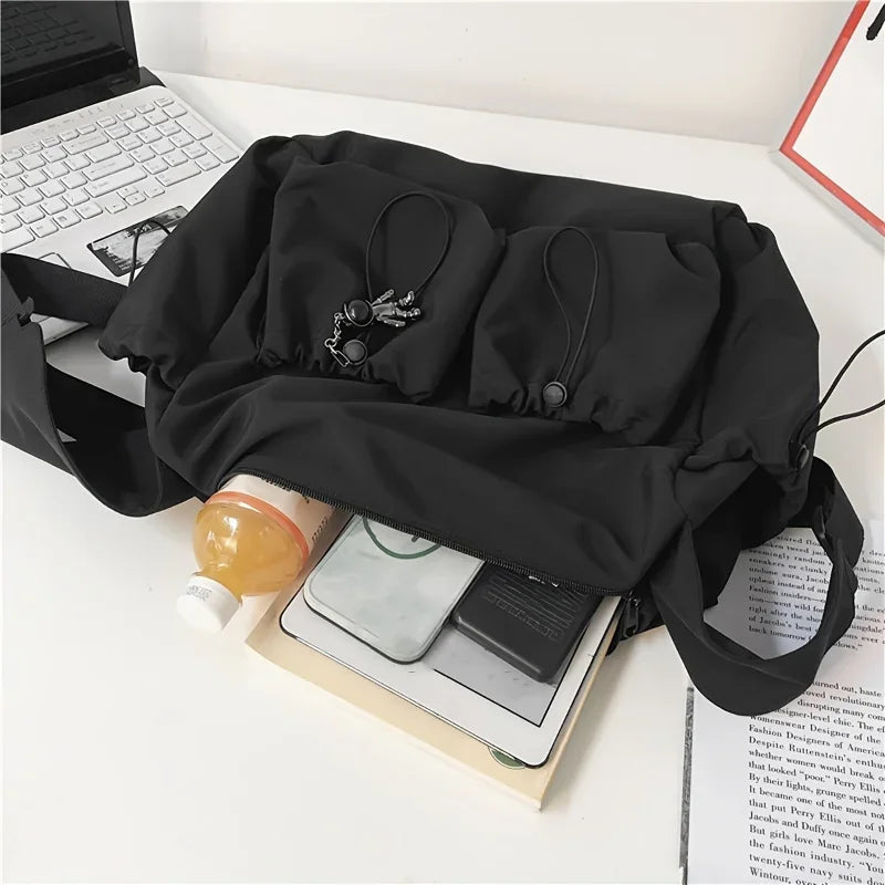 Fashionable Crossbody Bag with Stylish Charm & Drawstring Accent